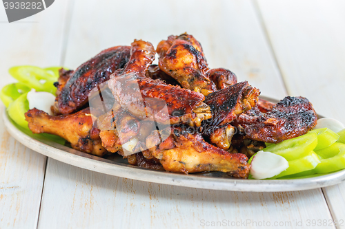 Image of Delicious chicken wings in a honey glaze.