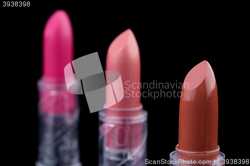 Image of bright lipsticks on a black background