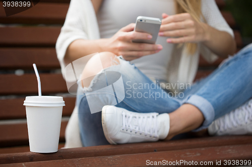 Image of beautiful girl on the street corresponded by phone. 