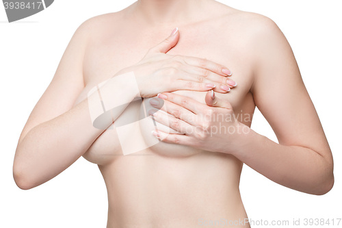 Image of Examining breasts. Close-up of young shirtless woman examining her breasts while. Isolated white background