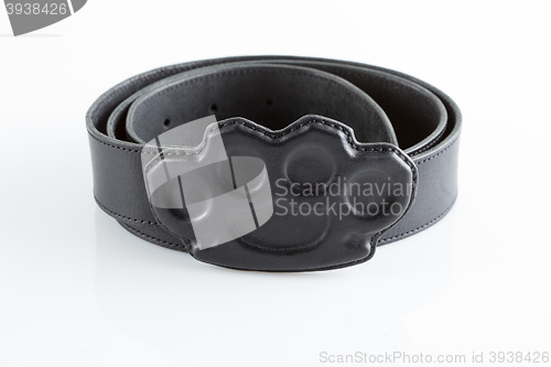Image of black belt with a buckle in the form of brass knuckles