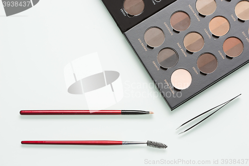 Image of Eye shadows of different colors and make-up brushes