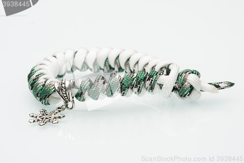 Image of green braided bracelet on white background. snowflake