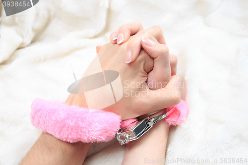 Image of Male and female hands in handcuffs. sex Toys