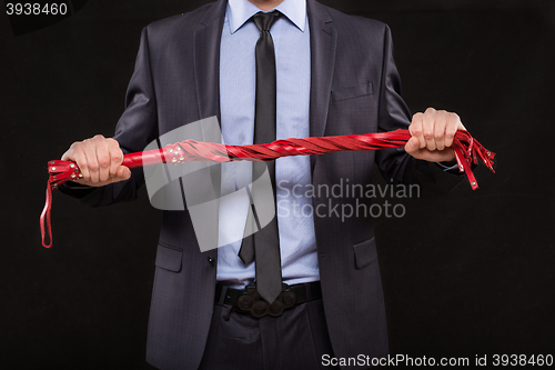 Image of man in business suit with chained hands. handcuffs for sex games