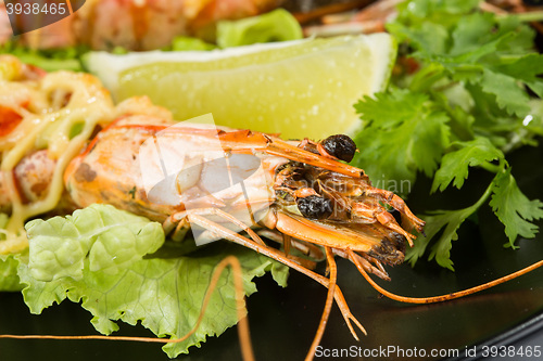 Image of perfect dish with shrimps on a black plate. seafood