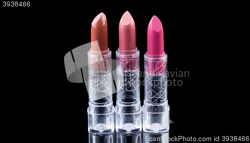 Image of bright lipsticks on a black background