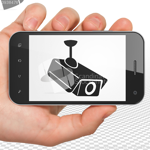 Image of Privacy concept: Hand Holding Smartphone with Cctv Camera on display