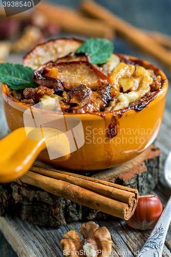 Image of Bowl of porridge with apple, nuts and cinnamon.