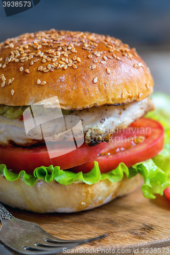 Image of Burger with salad and chicken.