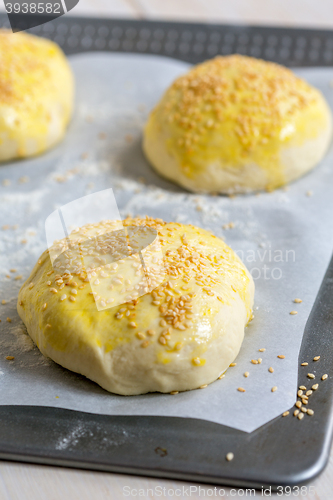 Image of Billets dough for baking buns with sesame seeds.