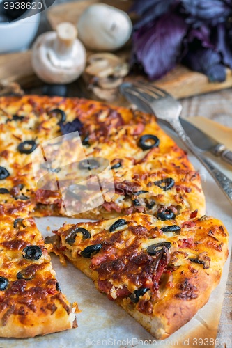 Image of Piece of delicious pizza with sausage and cheese.