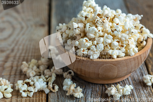Image of Popcorn in wooden bowl closeup.