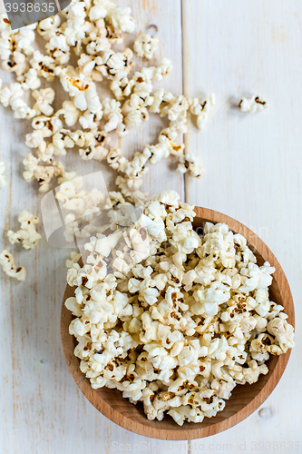 Image of Popcorn in wooden bowl. View from above.