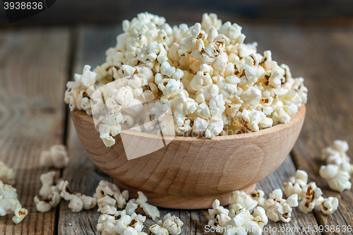 Image of Wooden bowl with popcorn closeup.