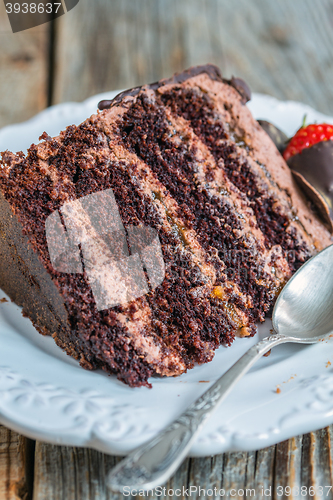 Image of Plate with chocolate cake and teaspoon.