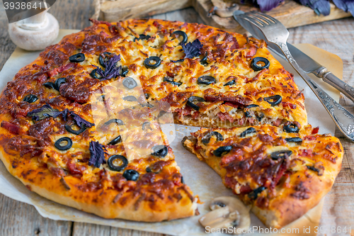 Image of Large pizza with sausage, mushrooms and cheese.