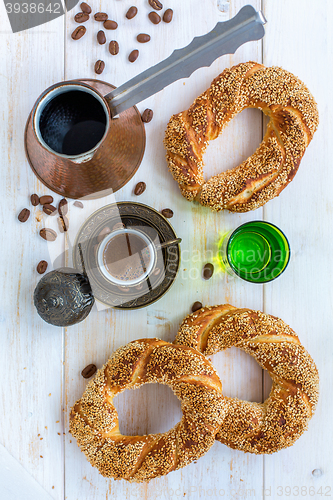 Image of Turkish coffee and bagels with sesame seeds.