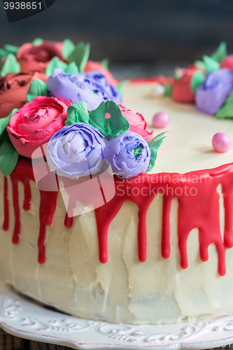 Image of Cake with red chocolate and flowers.