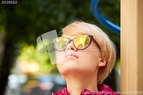 Image of Young woman with blond hair wearing sunglasses