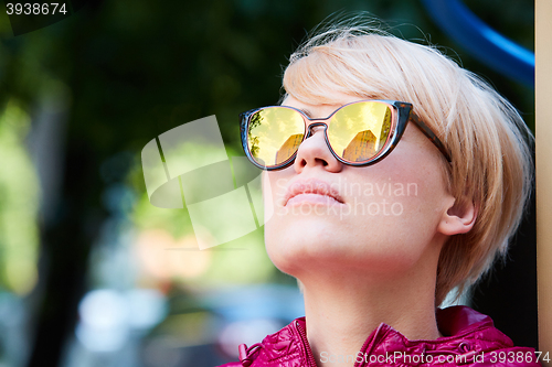 Image of Young woman with blond hair wearing sunglasses