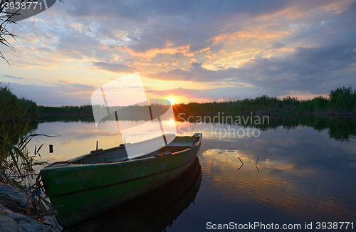 Image of fisherman boat at sunset 