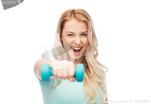 Image of smiling beautiful young sporty woman with dumbbell