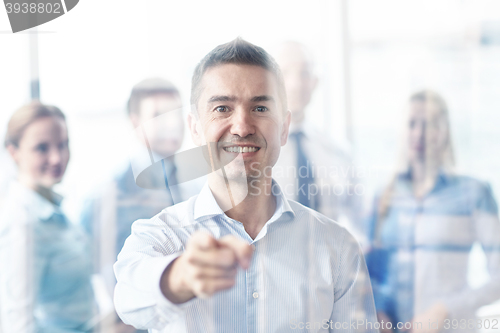 Image of group of smiling businesspeople meeting in office