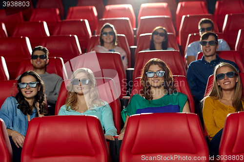 Image of happy friends watching movie in 3d theater