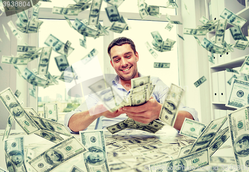 Image of happy businessman with heap of money