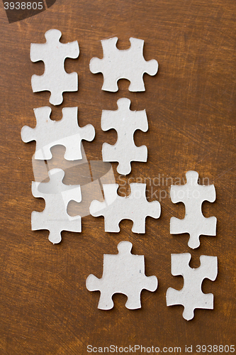 Image of close up of puzzle pieces on wooden surface