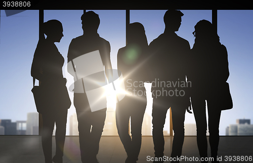 Image of people silhouettes over office background