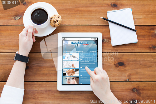 Image of close up of woman with tablet pc on wooden table