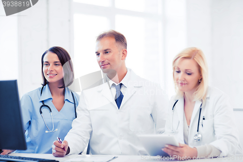 Image of doctors looking at computer on meeting