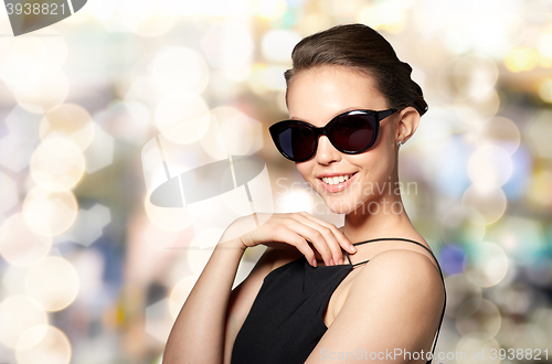 Image of beautiful young woman in elegant black sunglasses