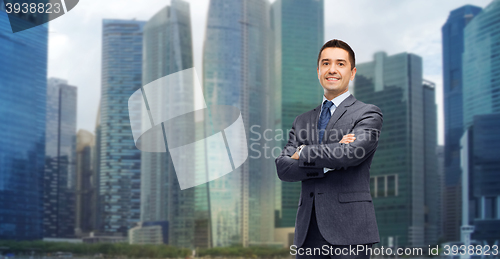 Image of happy smiling businessman over singapore city 