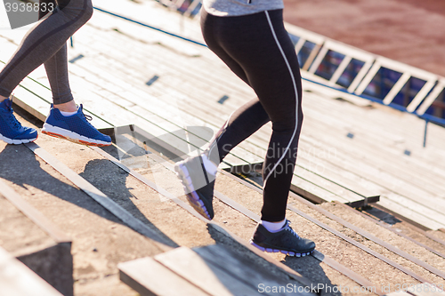 Image of close up of couple running downstairs on stadium