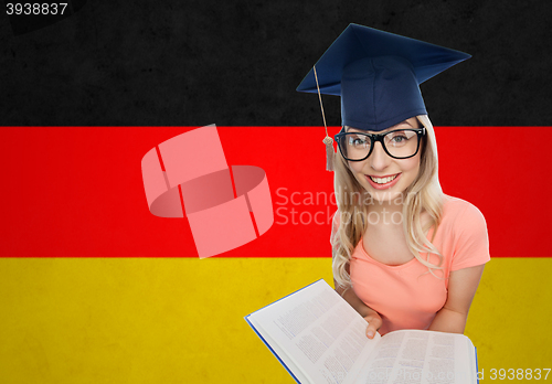 Image of student woman in mortarboard with encyclopedia