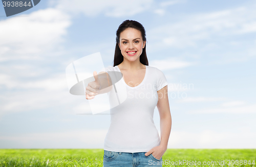 Image of happy womanin white t-shirt showing thumbs up