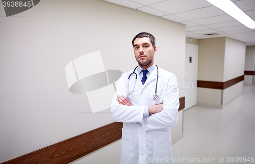 Image of doctor with stethoscope at hospital corridor