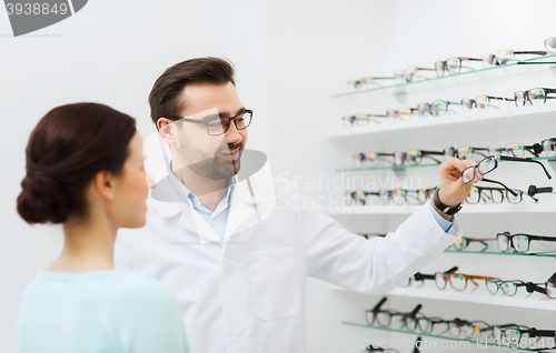 Image of optician with glasses and woman at optics store