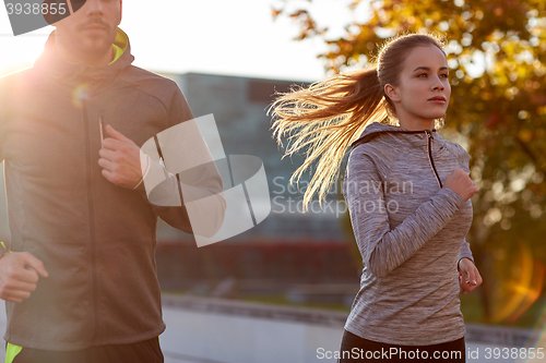 Image of couple running outdoors