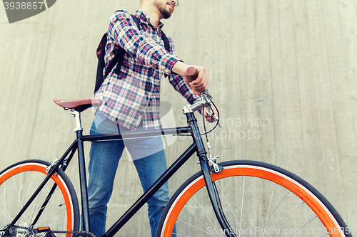 Image of hipster man with fixed gear bike and backpack