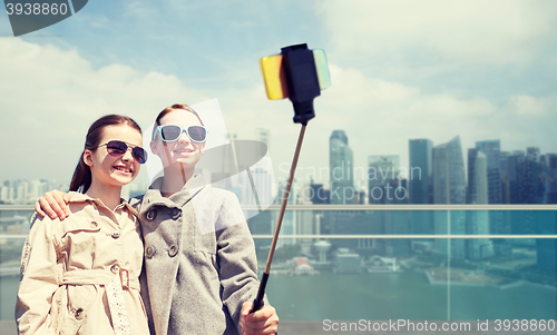 Image of girls with smartphone selfie stick in singapore