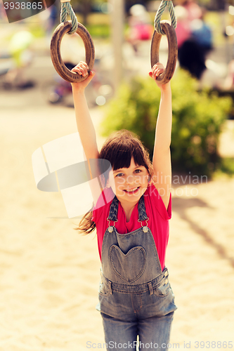 Image of happy little girl on children playground