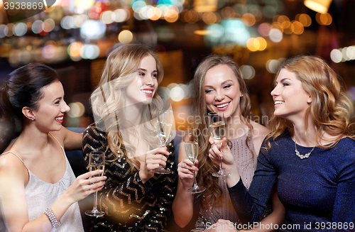 Image of happy women with champagne glasses at night club