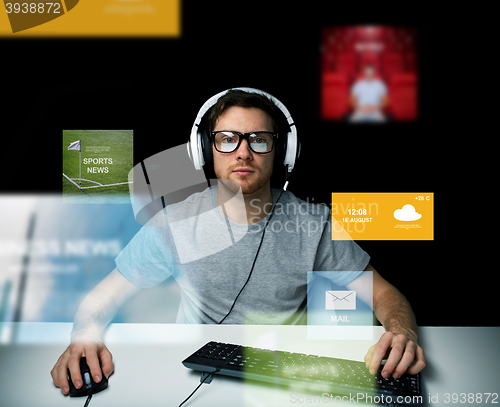 Image of man in headset computer over virtual media screens