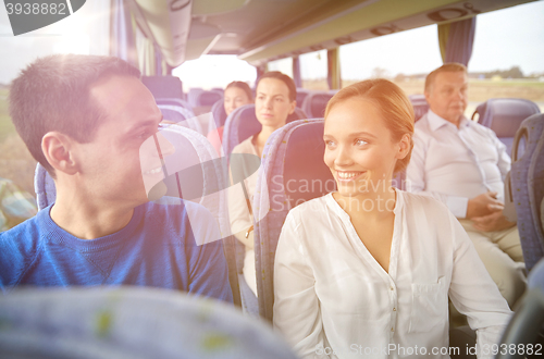 Image of group of happy passengers in travel bus