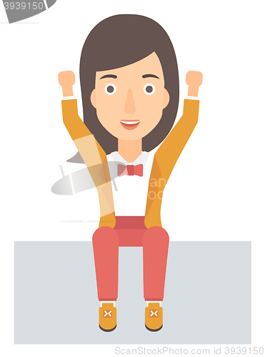 Image of Woman sitting with raised hands up.