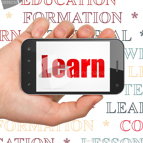 Image of Studying concept: Hand Holding Smartphone with Learn on display